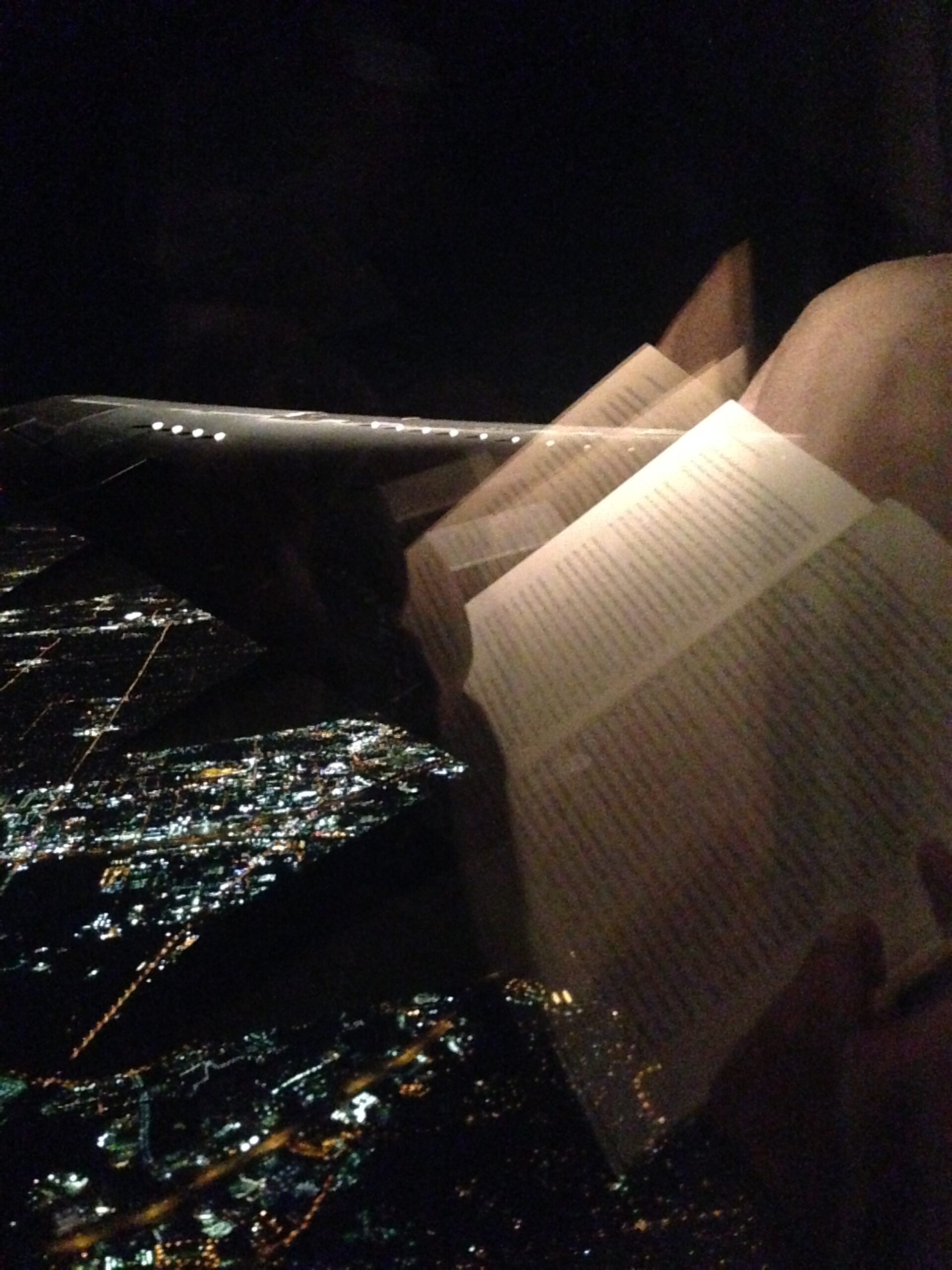 An open book on a night flight over a city